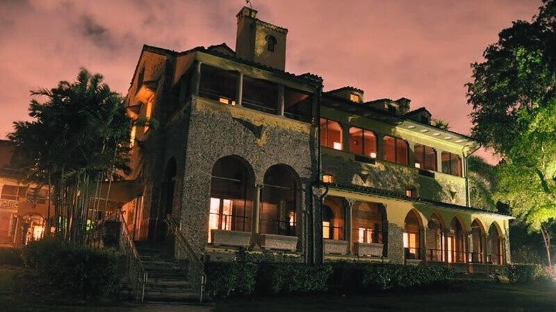 The Deering Estate, a historic mansion in Palmetto Bay, glows at night, adding to its allure as one of the most haunted places in Florida.