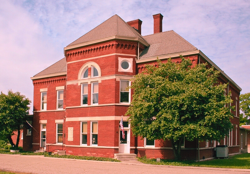 A red brick building with a white roof, representing Central State Hospital in Indianapolis, established in 1848 for the criminally insane, now considered one of the most haunted places in Indiana.