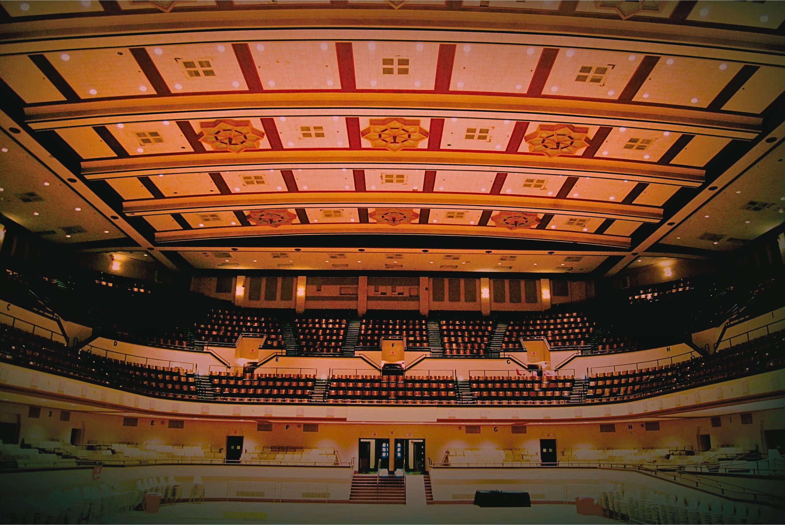 Shreveport Municipal Auditorium, an expansive auditorium featuring a tall ceiling, recognized for its haunted reputation and rich musical heritage since 1929.