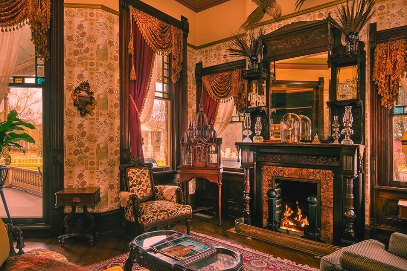 An elegant Victorian living room at The Empress of Little Rock, adorned with vintage decor and sophisticated furnishings.