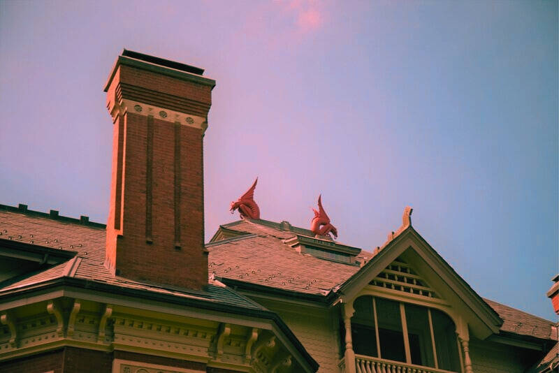 Top view of the Gargoyle House, showcasing two red stone gargoyles, a notable 1800s landmark in Atchison, Kansas.