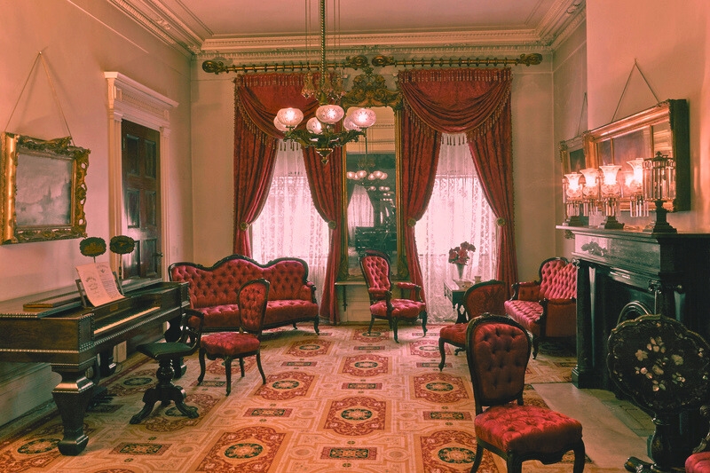 The parlor of the Merchant's House Museum in New York, showcasing elegant decor and historical significance, despite being one of the most haunted places in New York City.