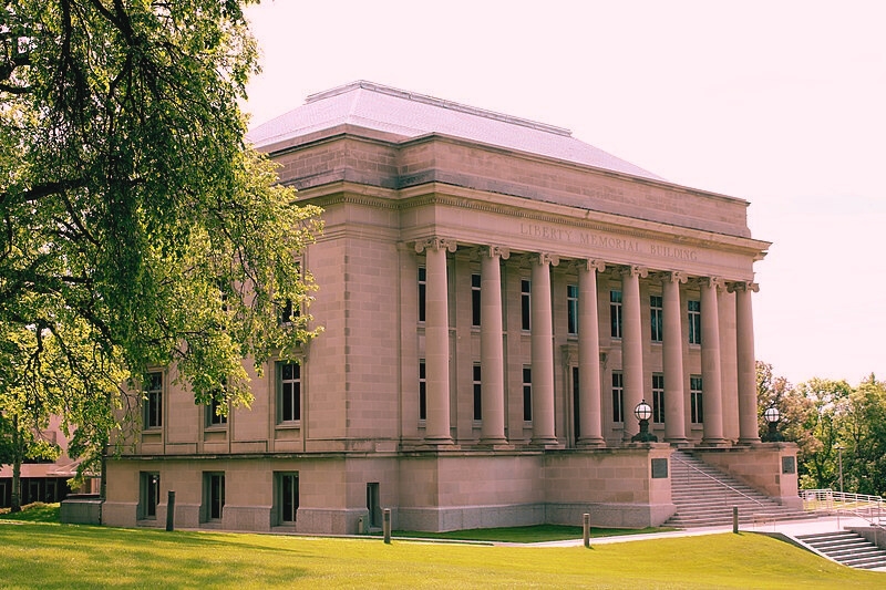 The Liberty Memorial Building, with its columns and surrounding tree, is the oldest building on the North Dakota Capitol grounds.