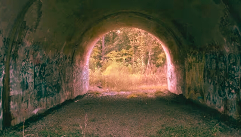An abandoned tunnel with graffiti, reflecting the ghostly lore of Lydia's Bridge near Jamestown, North Carolina.