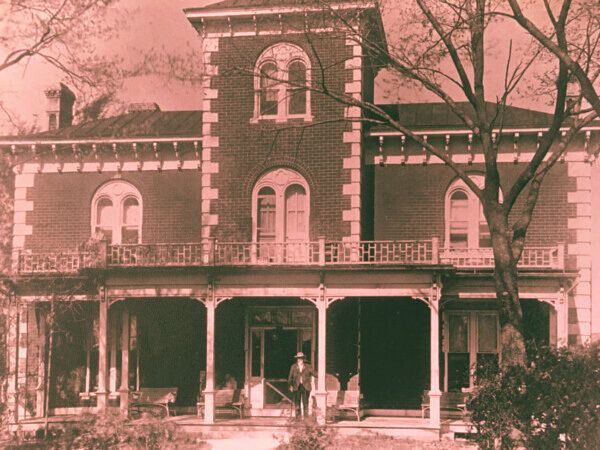 Vintage photo of the haunted Peel Mansion, a spacious brick house in Arkansas.