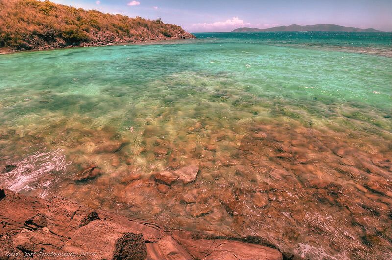 Breathtaking ocean view from the rocky coastline of Jumbie Beach, famous for its haunted tales in the U.S. Virgin Islands.
