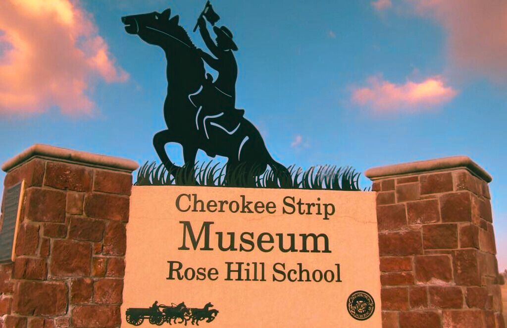 Sign for the Cherokee Strip Museum against a blue sky.