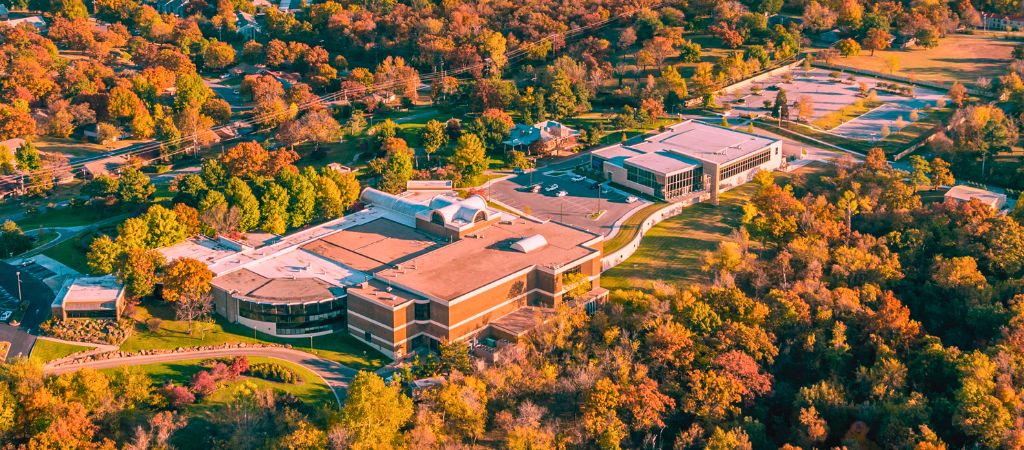 Aerial view of the Gilcrease Museum in Oklahoma, surrounded by trees and hills.